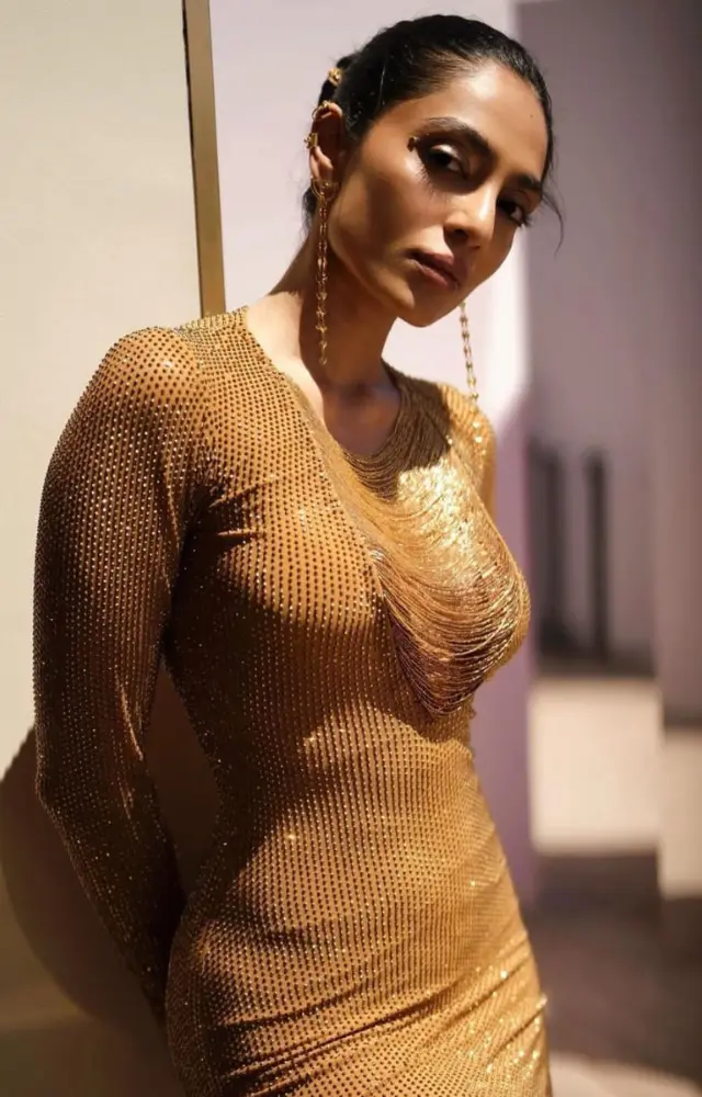 Sobhita Dhulipala stunned in a golden outfit that was both regal and avant-garde. Her gown featured intricate patterns and a dramatic silhouette.