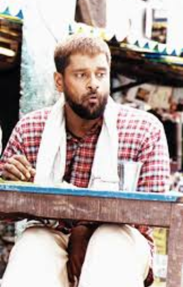 A socially isolated gravedigger who finds unexpected friendship, highlighting Vikram`s nuanced portrayal of innocence and raw emotion.
