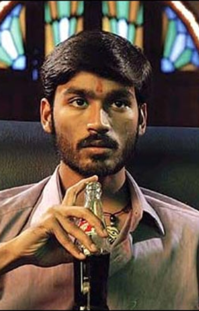 Dhanush plays a young, street-smart gangster who is ruthless yet vulnerable. This gritty underworld showcased his raw energy and intensity.