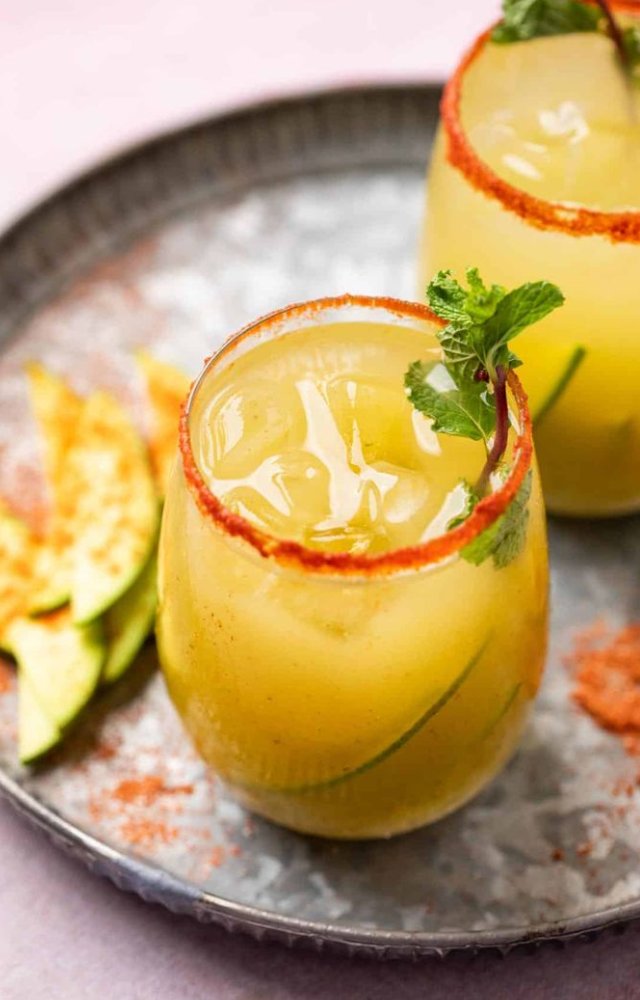 Blend boiled raw mango pulp with mint, roasted cumin powder, and jaggery. Dilute with water and serve cold.