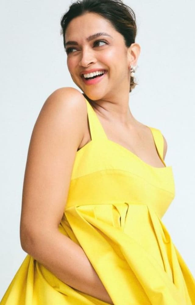 The mommy-to-be looked as bright as sunshine as she smiled and posed for the camera in a stunning yellow dress.
