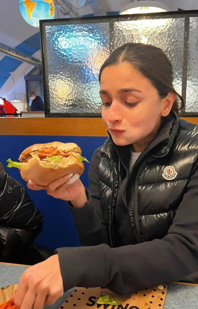 In this picture, Alia is seen enjoying a yummy and delicious-looking burger