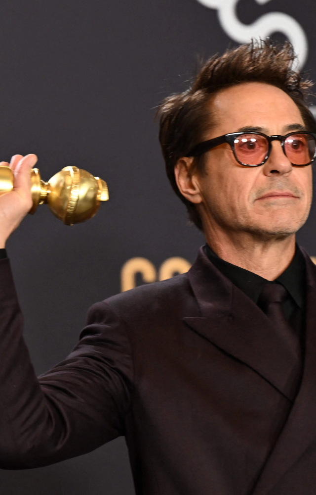 Robert Downey Jr. poses with the award for Best Performance by a Male Actor in a Supporting Role in any Motion Picture for `Oppenheimer`.