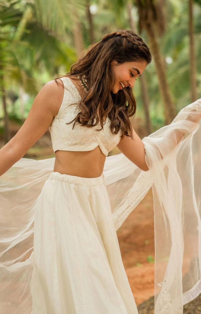 Pooja Hegde carries her tradition with her throughout by featuring her beauty in lehenga`s and other traditional wears.