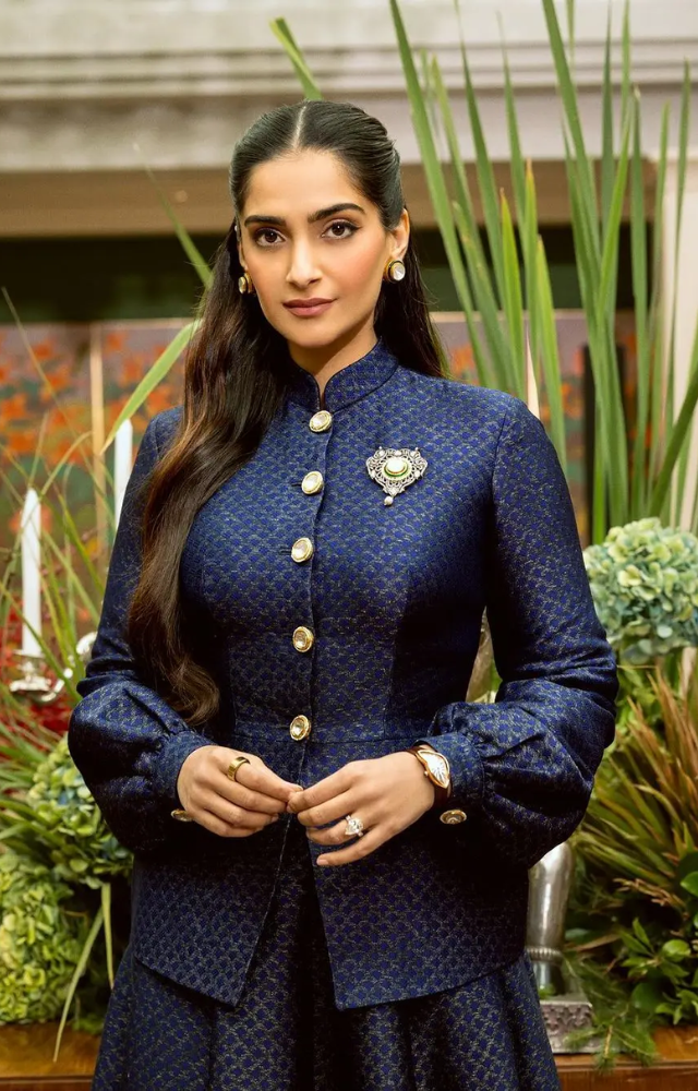 She paired it with a matching floor-length skirt. The Neerja actress completed her look with a wristwatch, rings, and bold gold earrings. 