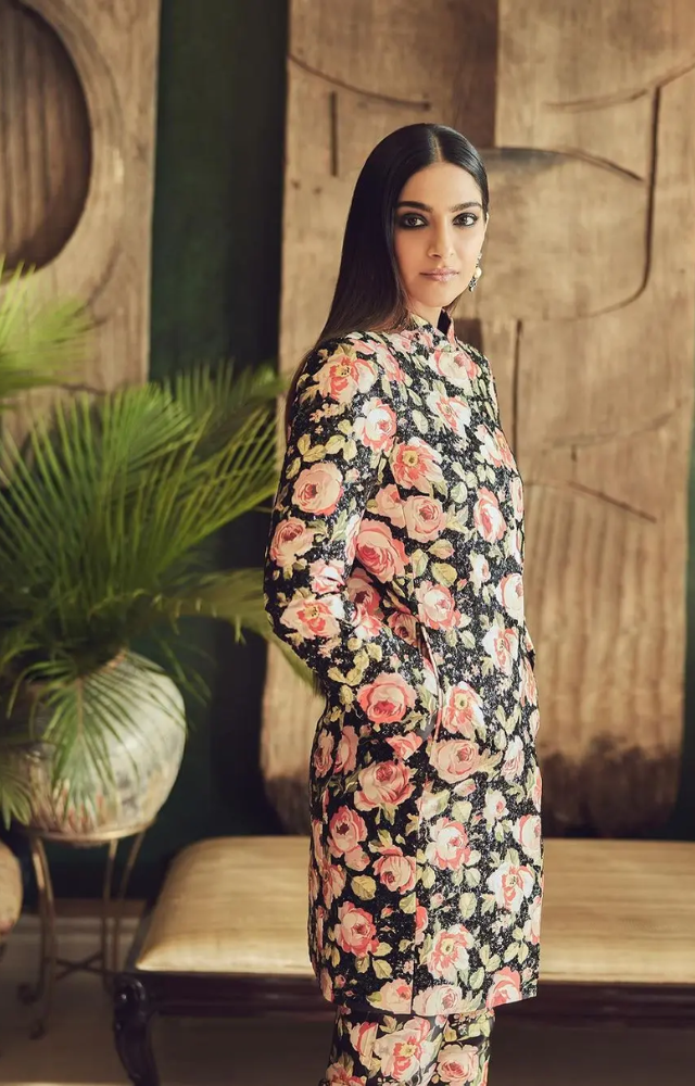Embracing a floral theme, Sonam Kapoor wore a suit adorned with charming pink and green patterns. 