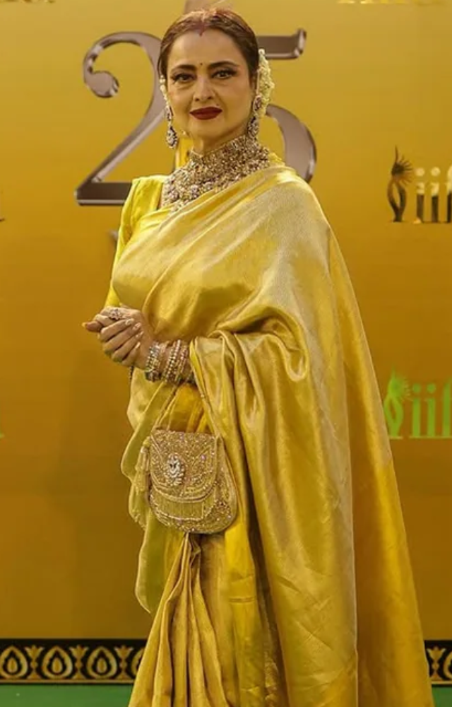 Staying true to her iconic style, Rekha mesmerized in a luxurious gold Kanjeevaram saree, paired with a full sleeved blouse. 