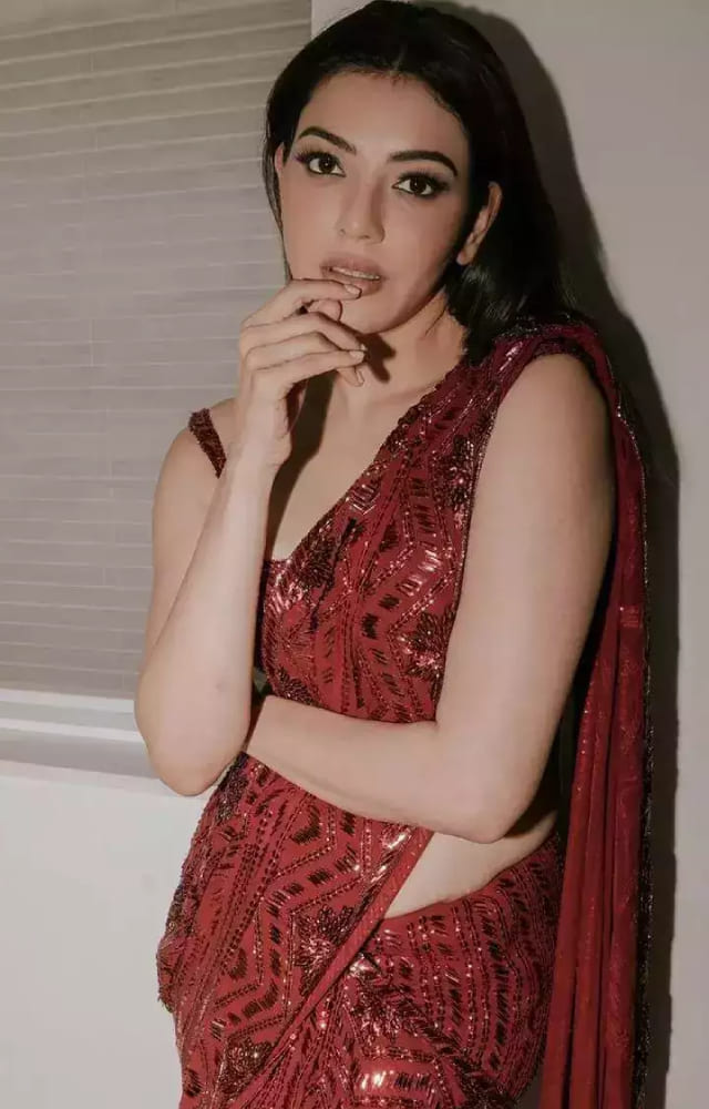 Kajal Aggarwal looks stunning and ravishing in a red sequin saree. Her minimal makeup highlights the saree effortlessly. Be a headturner with this ethnic wear.