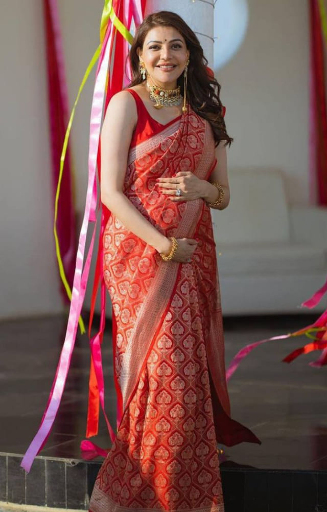 The doted mommy looks gorgeous in a red and silver silk saree with intricate zari work. Her pregnancy glow makes her look effortlessly elegant.