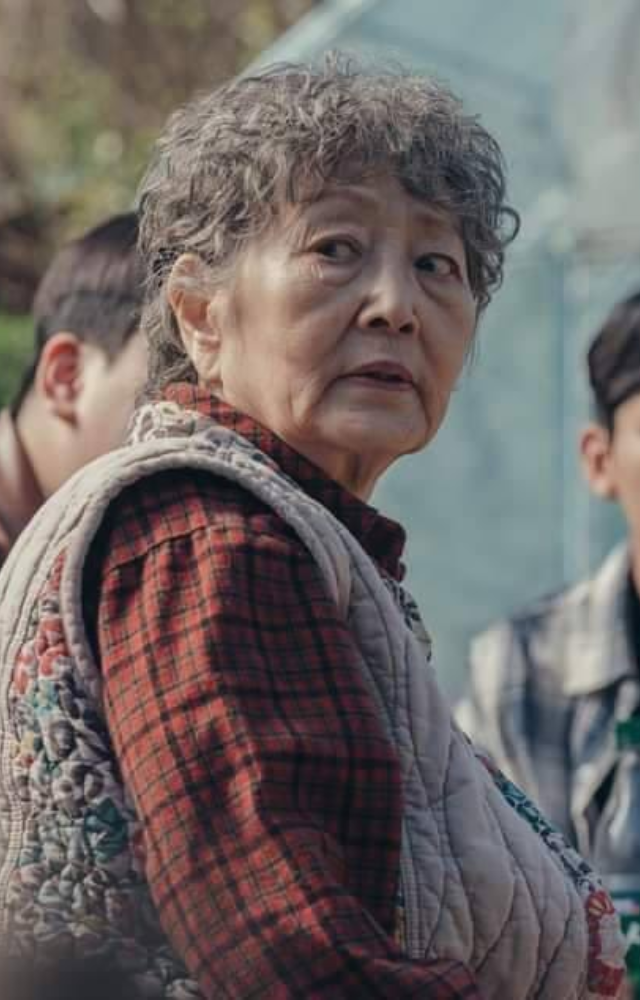 Appears as a wise elderly resident, adding emotional weight and grounding the story in local folklore.