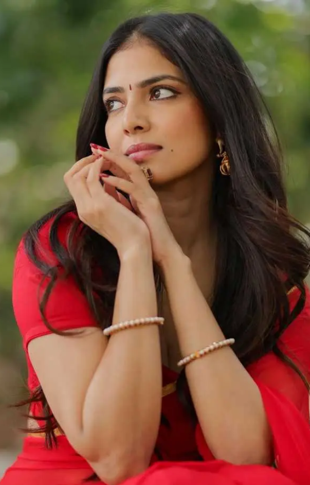 Malavika Mohanan’s red saree exudes timeless elegance, enhancing her overall grace and sophistication.