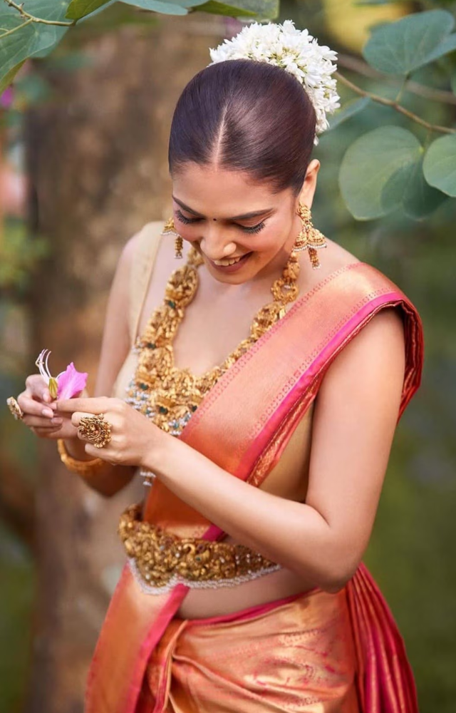 Classic South Indian temple jewelry and fresh flowers in her hair, embodying timeless elegance.