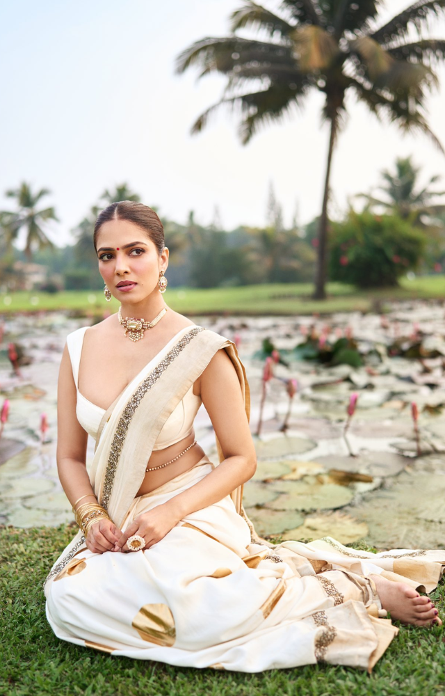 Malavika often styles this with a modern sleeveless blouse, keeping the look minimalistic yet graceful, perfect for festive occasions