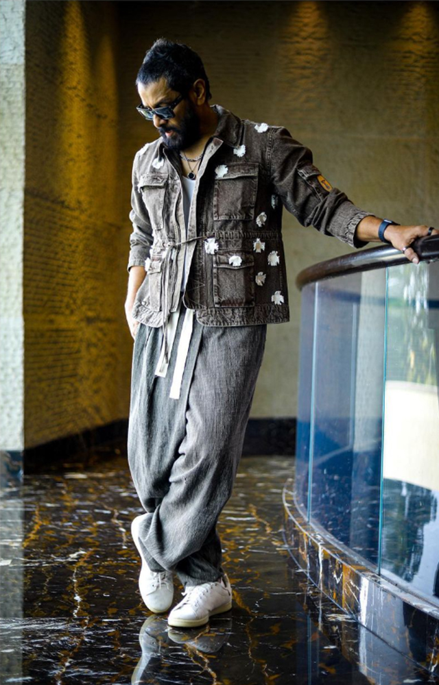 Chiyaan Vikram oozes style and elegance in his distinctive attire, striking a pose that defines his handsome allure.