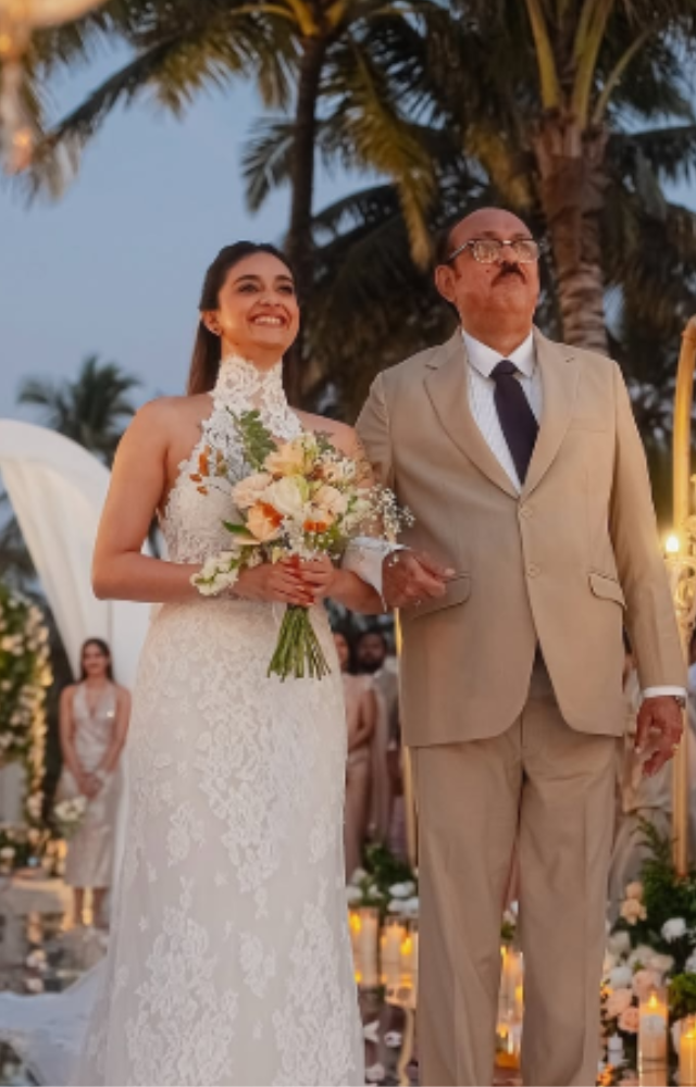 Keerthy looked stunning in a lace white gown with a cinched waist and elegant turtle neck design