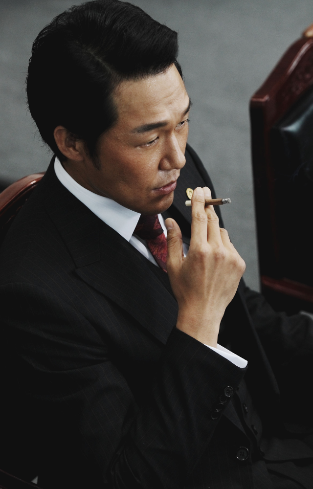 In this breakout role, he plays Lee Joong-gu, a ruthless and fiercely loyal gangster. His performance is iconic, with many memorable scenes and lines.