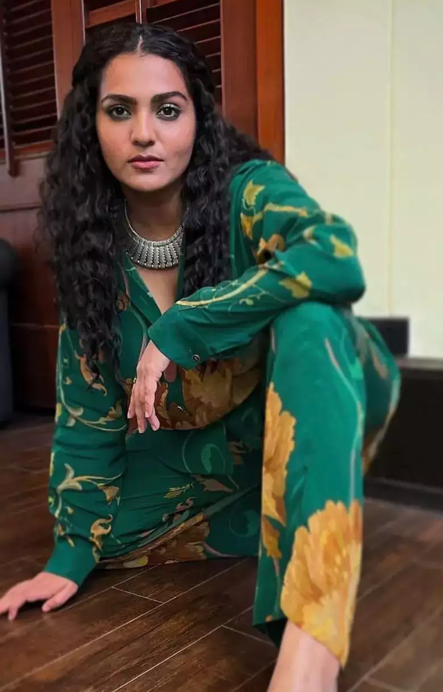 Parvathy often combines traditional Indian attire with modern elements, creating a fusion that stands out