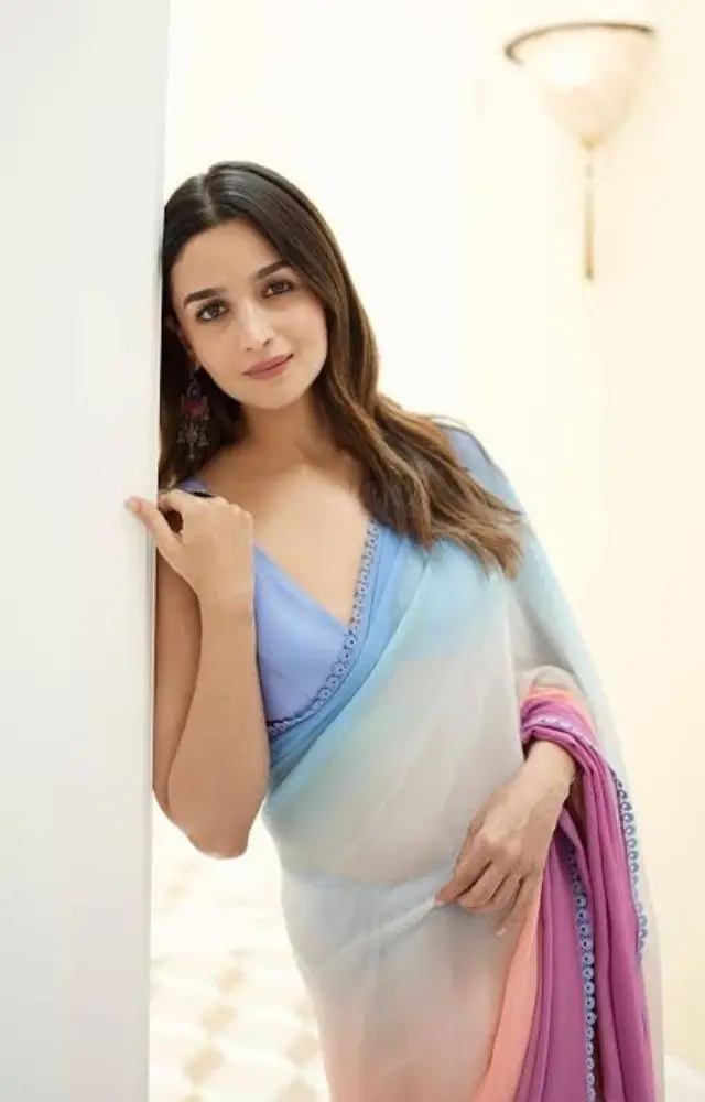 Alia Bhatt stuns in a sheer blue ombré pastel saree, showcasing her edgy and stylish side. This ensemble is a perfect blend of fashion and grace