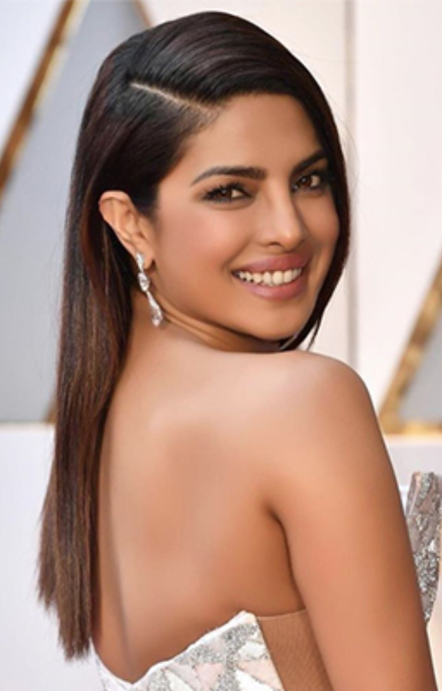 A sleek, straight hairstyle looks elegant and glamorous, especially when paired with statement earrings.