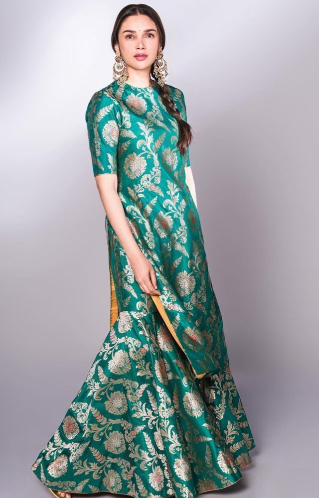 Shararas with zari work add a traditional touch. Example: Aditi Rao in a stunning sharara set.