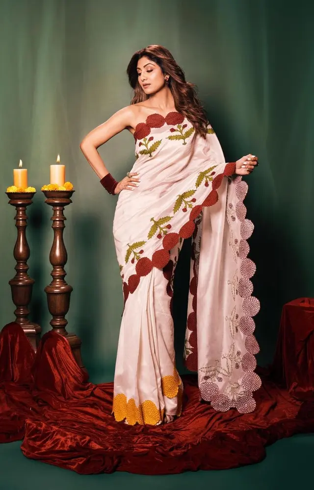 Shilpa Shetty raised the bar high with this white saree with a red, green and orange floral border. She paired it with a strapless blouse