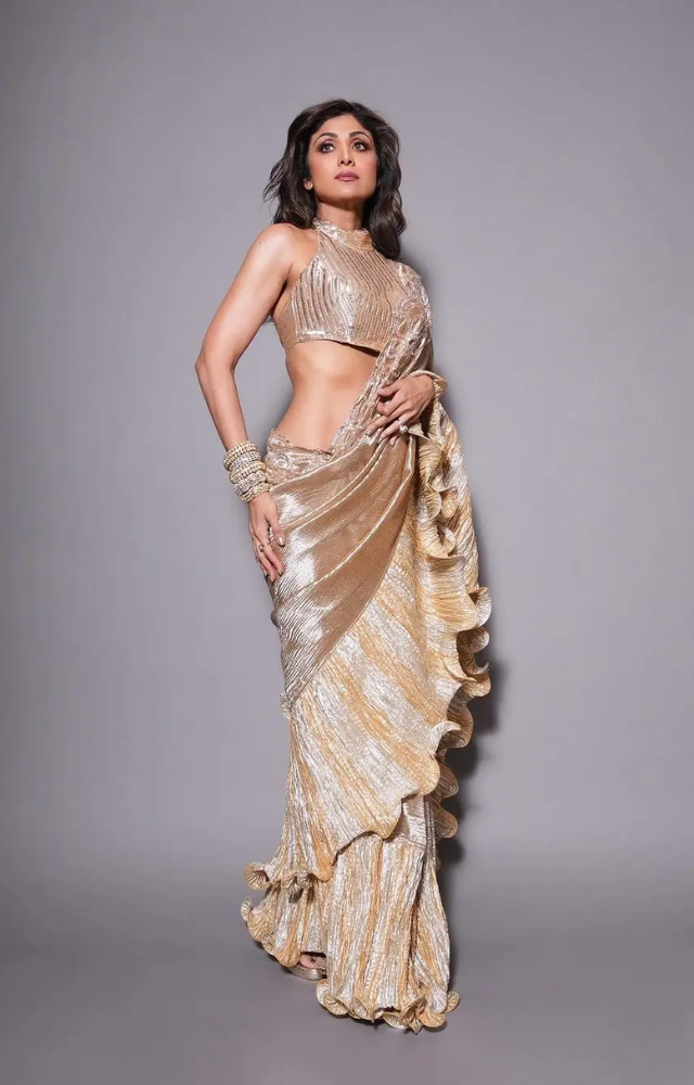 Shilpa Shetty looked stunning in a shiny rose gold saree with cute frills on the edges. 