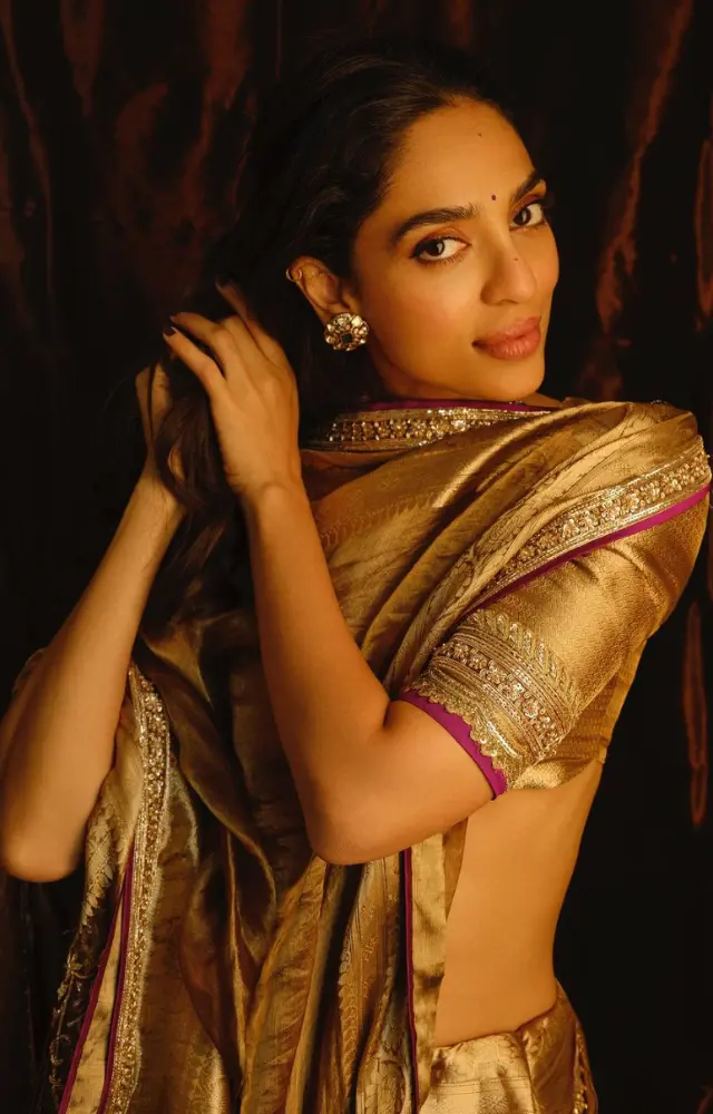 The actress wore a stunning golden saree adorned with a delicate pink border