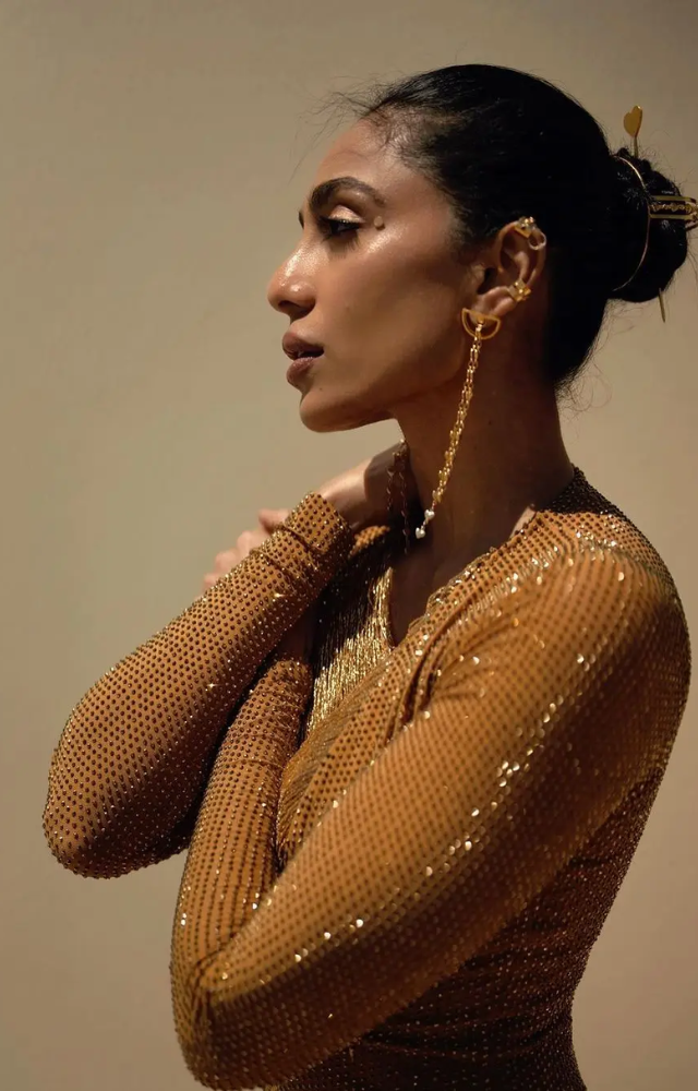 She accessorized with long earrings, styled her hair in a bun, and wore heels.
