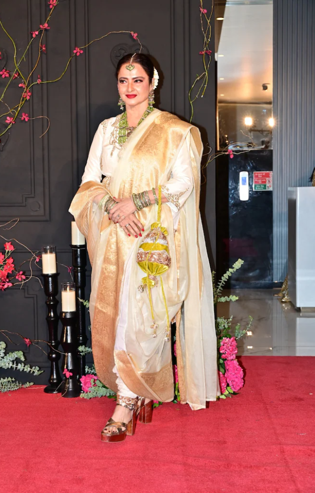 Ever gorgeous Rekha looked elegant at the function in a pearl white and gold Indo western ensemble.