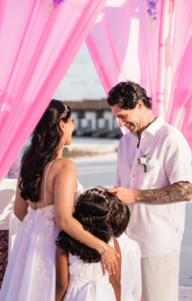 Their three children, Nisha, Noah, and Asher, participated in the ceremony.
