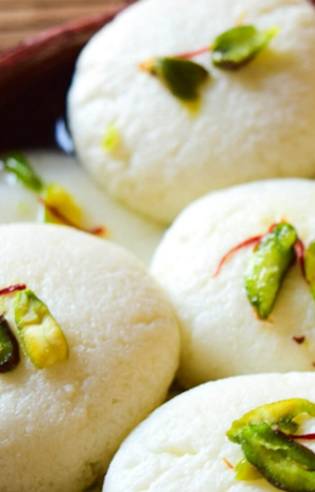 Soft, spongy cheese balls soaked in sugar syrup, a popular dessert.