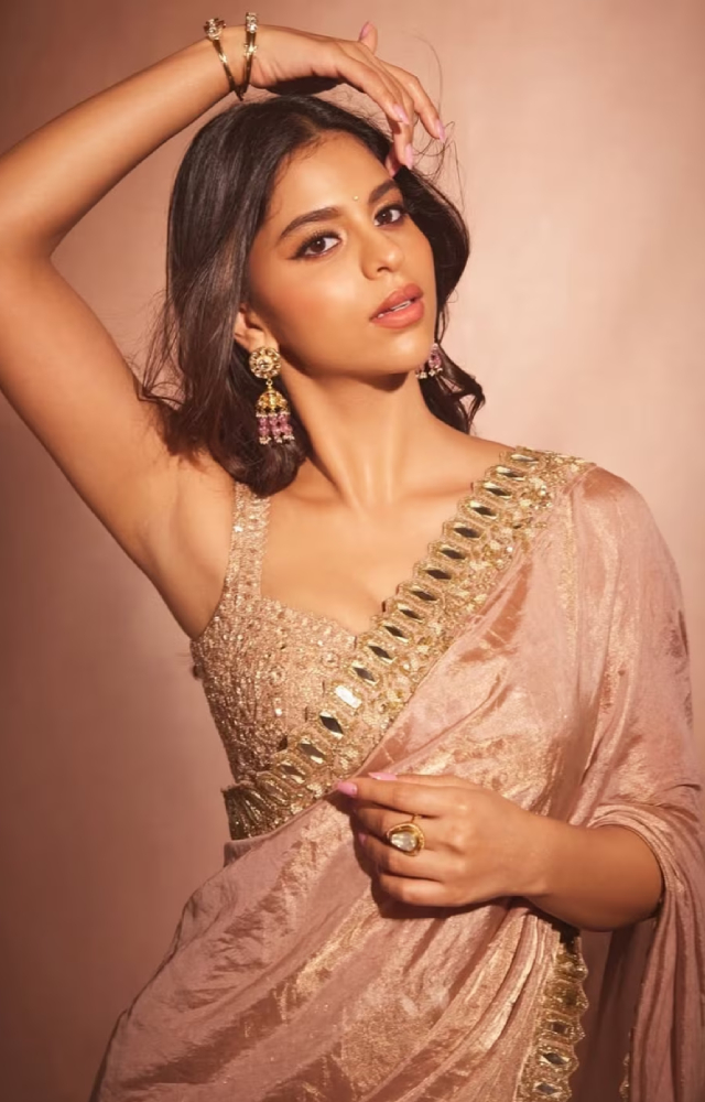 Suhana`s pastel peach saree with mirror work is the easy to replicate for all the GenZ divas. Complete the look with statement jewelry and minimal makeup.
