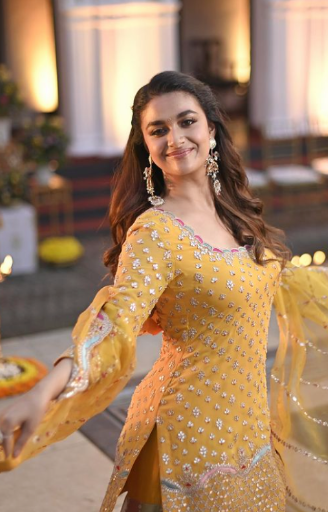 Keerthy Suresh celebrated the occasion with traditional flair and modern elegance. She chose a sparkling yellow embellished sharara suit that illuminated 