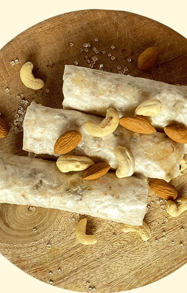 A unique sweet made from thin rice starch sheets, filled with sugar and ghee, offering a crispy and melt in your mouth experience.