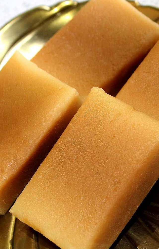 A classic treat made with gram flour, sugar, and ghee, known for its rich, crumbly texture and royal origins.