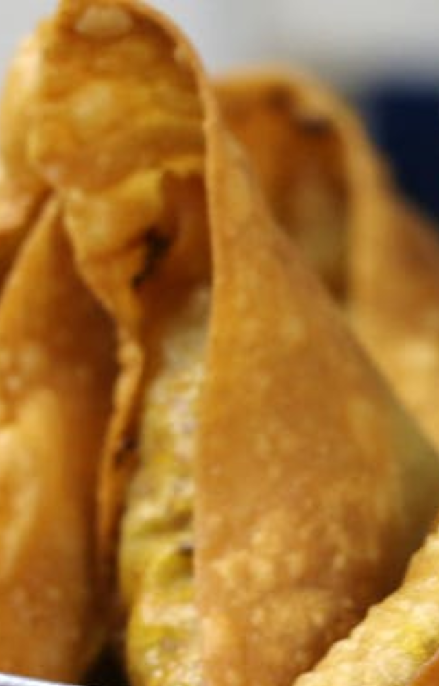 Anushka enjoys the chicken samosas, which are equally delicious and popular among patrons.
