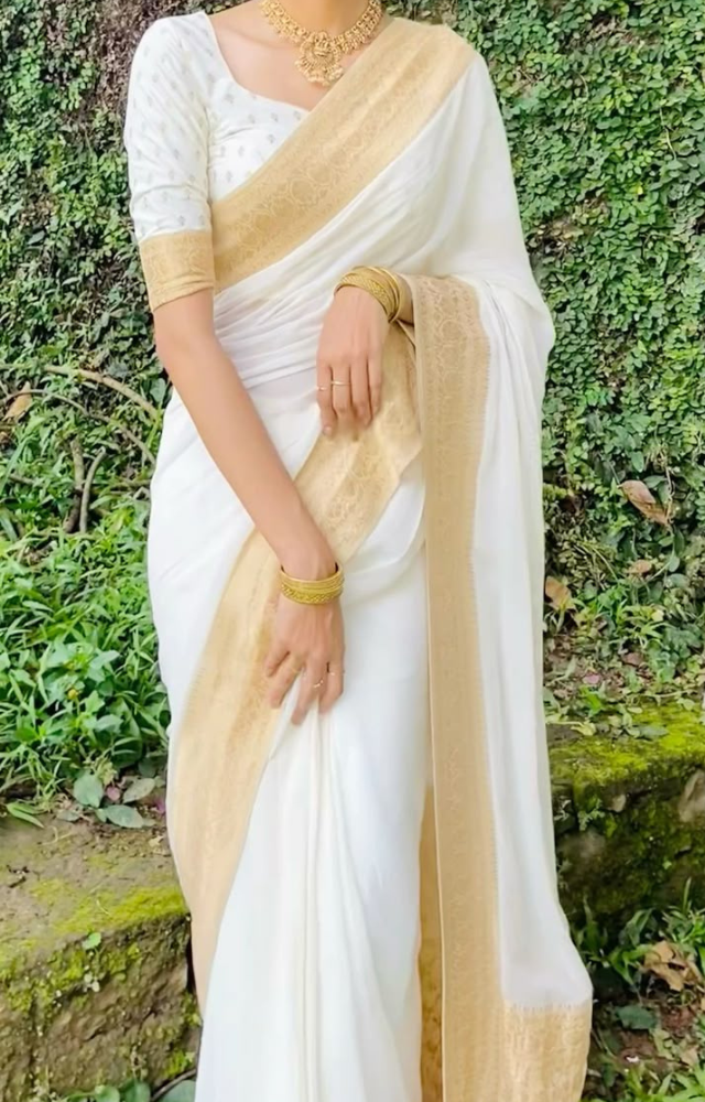 Opt for a classic Kasavu saree with a golden border, paired with a contrast blouse, gold jewelry & jasmine flowers for a timeless Vishu look.

