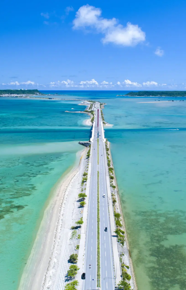 A scenic road in Okinawa suddenly disappears into the ocean at high tide, leading to confusion for unaware travelers.