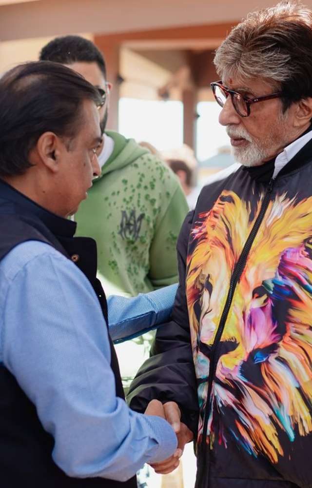 Power meets prestige as Mukesh Ambani warmly shakes hands with Bollywood legend Amitabh Bachchan at the grand pre-wedding event.