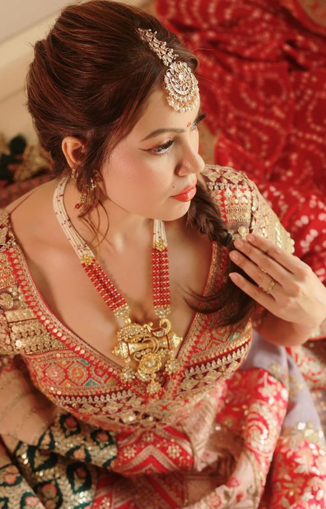 Munmun Dutta exudes elegance while expressing her affection for a crimson lehenga that enthrals with its timeless appeal and brilliant charm.