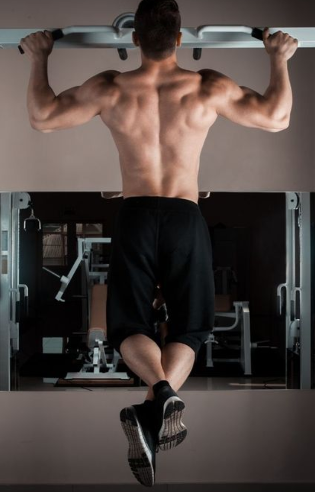Pull-ups are a bodyweight workout that mainly work the shoulders, biceps, and back. With your palms facing away from you, hang from a pull-up bar