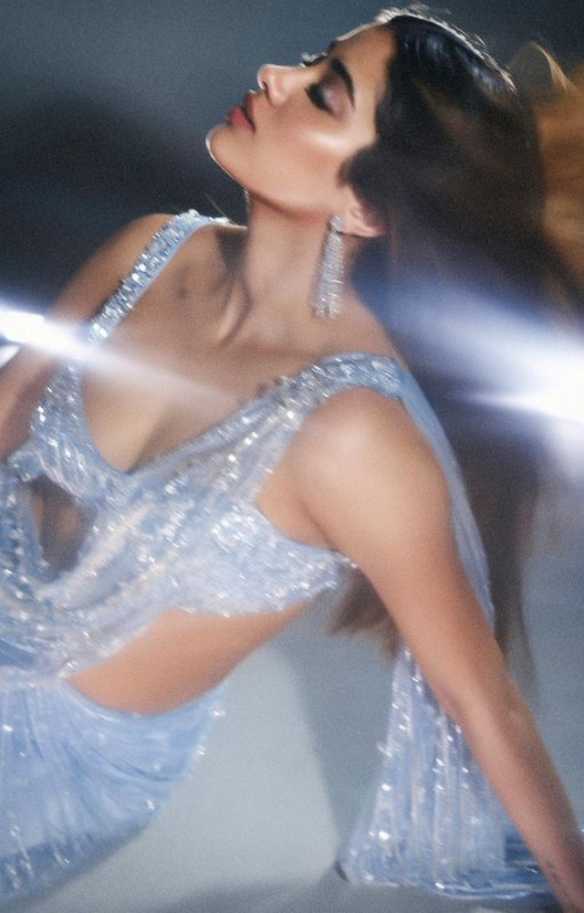Step into the world of grace and sophistication as Janhvi Kapoor dons a bewitching blue saree, making a statement with timeless style.