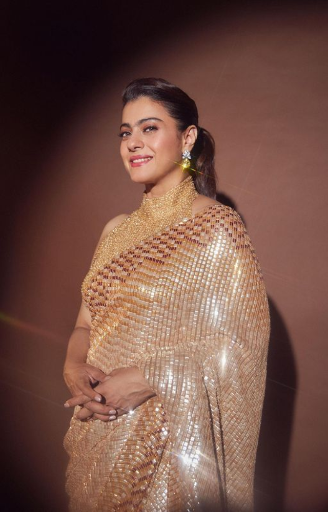 Kajol steals the show at any function when she wears a golden saree, radiating a timeless elegance and alluring brilliance.
