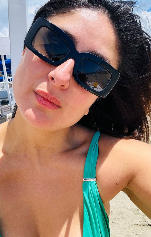 Kareena Kapoor, stylish in her black shades, enjoys the beach, her chic look perfectly complementing the sunny, relaxed atmosphere.