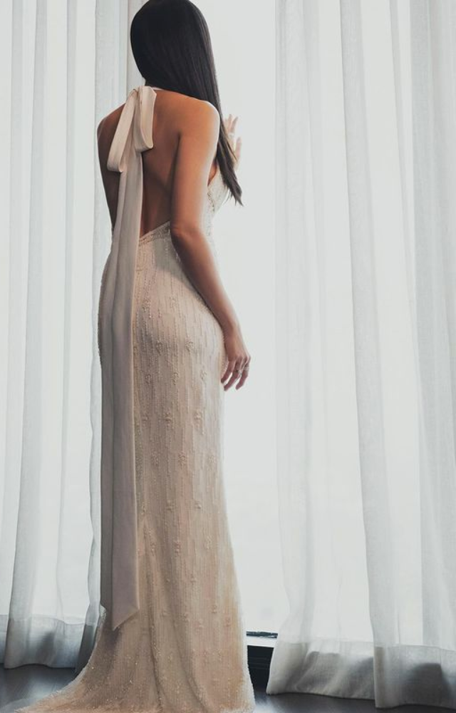 Karishma Tanna stuns in a backless white gown at Filmfare, epitomizing glamour and elegance, creating a red-carpet moment that turns heads with allure.