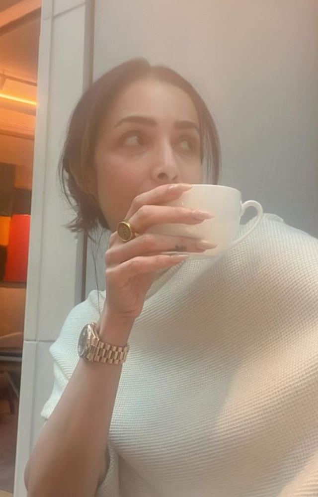 Indulging in a serene moment, Malaika Arora savors her coffee, capturing the tranquility of a quiet morning.