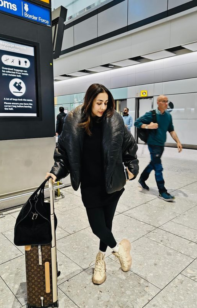 Malaika Arora strikes a stylish pose at the airport, exuding elegance and confidence as she travels to her next destination.