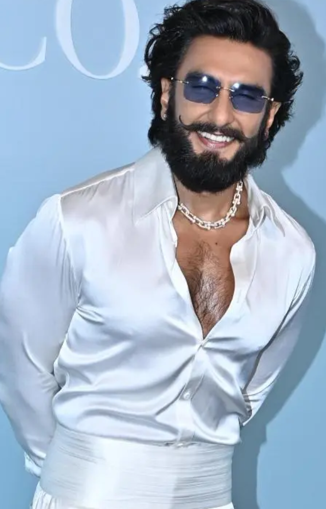 Ranveer Singh often accessorizes his outfits with stylish eyeglasses, adding a touch of sophistication to his look.