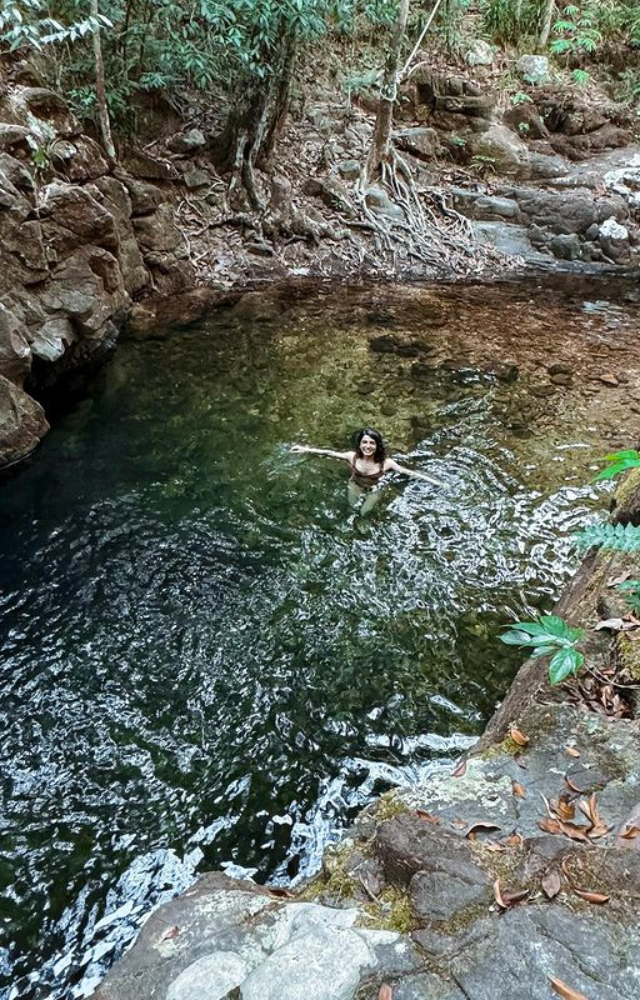 Dive into nature: Samantha swims in a pristine, natural setting, embracing the soothing atmosphere, a refreshing escape from the ordinary.