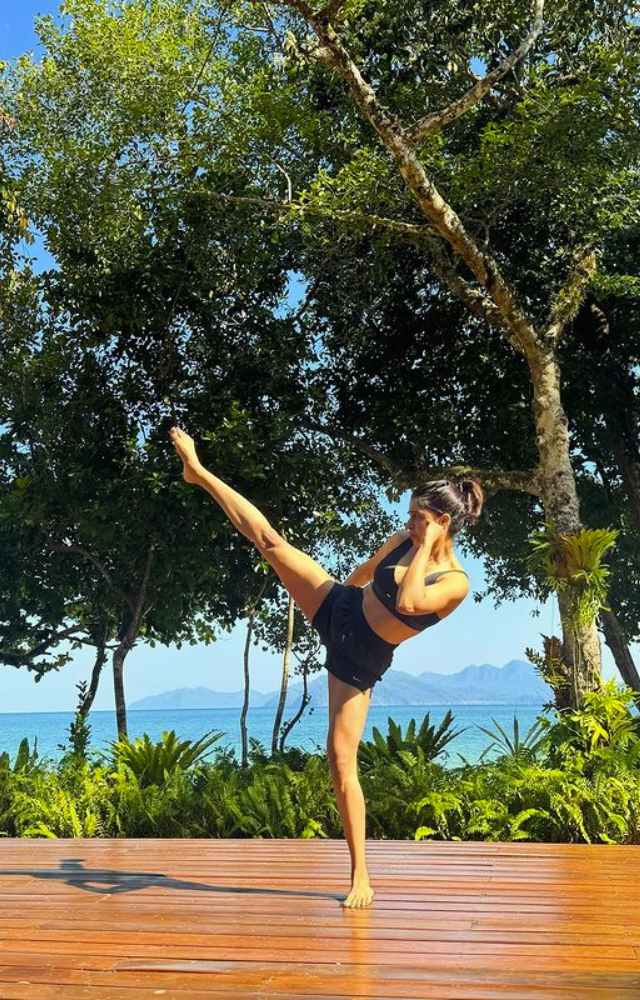 Samantha practices martial arts in the morning sun, showcasing strength and discipline in a golden dawn.